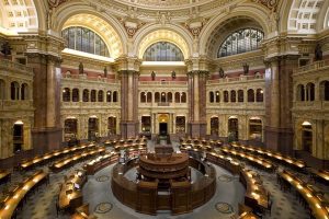 Interior de una sala parlamentaria o biblioteca legislativa monumental, representando un símbolo de las formas de gobierno y toma de decisiones políticas.