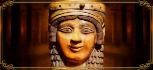 Escultura antigua de la diosa Ishtar, con rostro femenino sereno, corona decorada y cabello rizado, destacando su importancia como deidad mesopotámica del amor, la fertilidad y la guerra