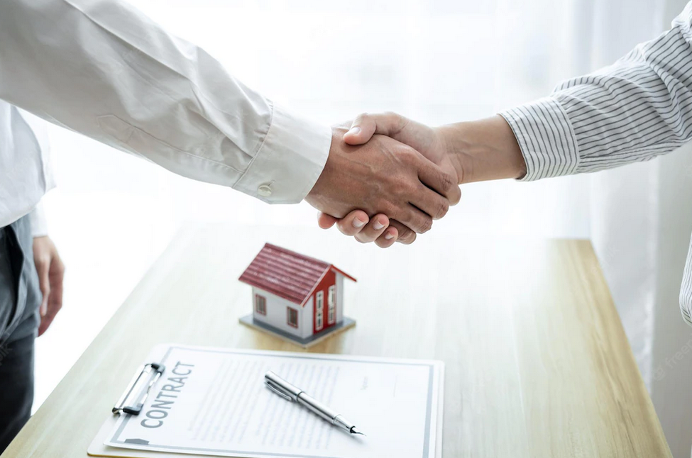 manos estrechadas después de firmar contrato de casa