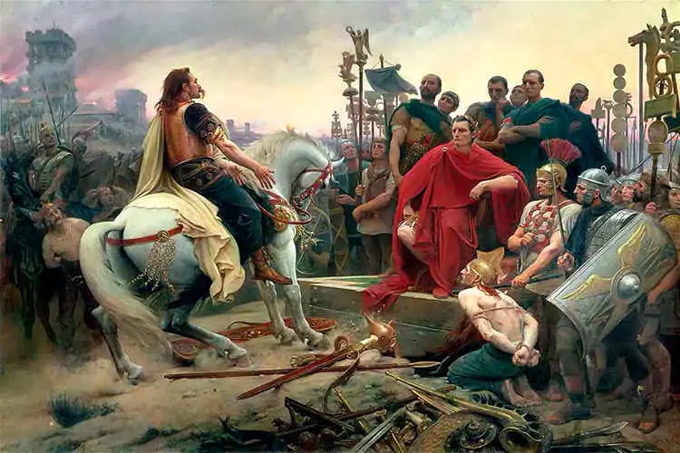 Vercingétorix arrojando sus armas a los pies de Julio César. Pintura de Lionel Royer, 1899, vía Wikimedia Commons.